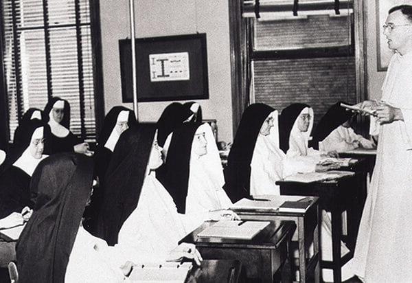 Black and white picture of the sisters in a classroom learning about theology